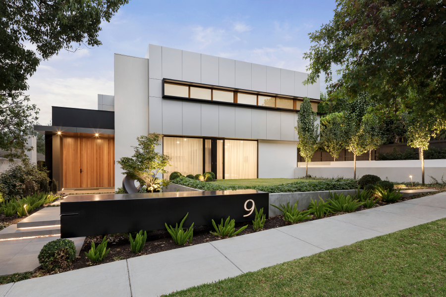 Exterior view of a luxury ultra-modern home with sleek design, large windows, and contemporary architecture.
